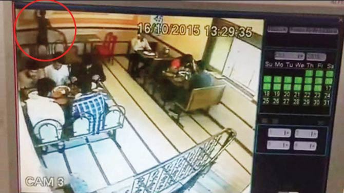 A video grab from Camera 3 at City Kinara shows the waiter tinkering with the regulator (top left corner) seconds before the mezzanine erupts into a blaze