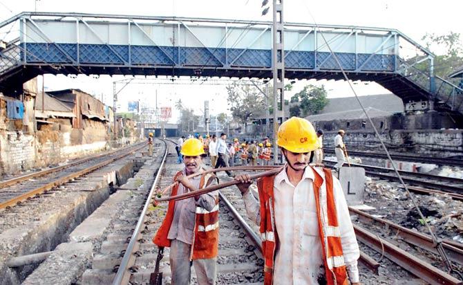 Workers repair a snapped overhead cable near Byculla station. With the upgraded system, commuters will receive timely announcements about untoward incidents. File pic for representation