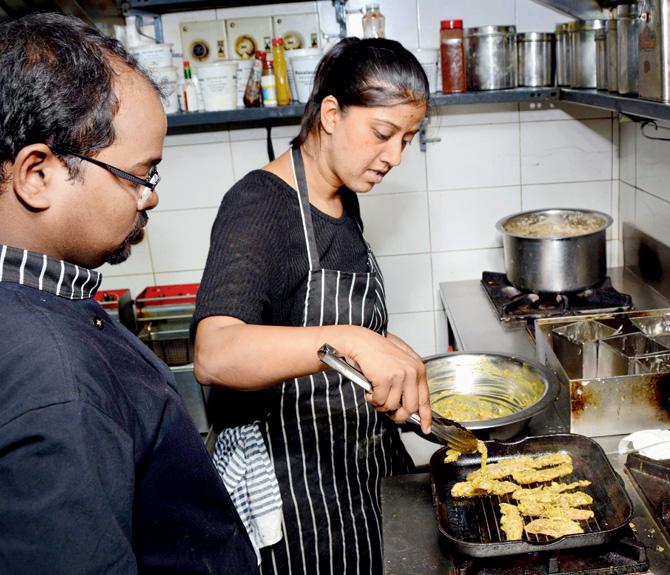 Executive Chef Kshama Prabhu and Chef Mahesh Behara try the chicken gyros