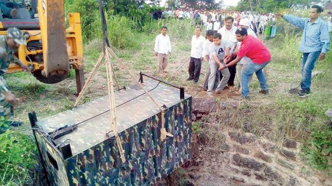 The cage with the trapped leopard was hauled up using a JCB