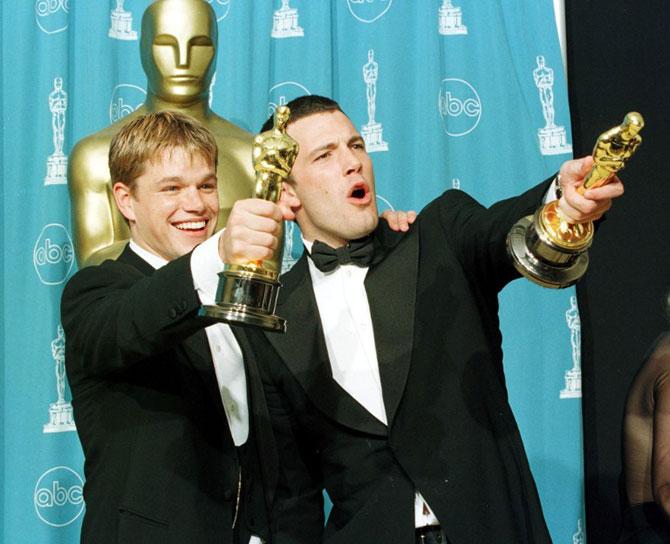 Matt Damon and Ben Affleck hold the Oscar awards they won for Best Original Screenplay for the film 