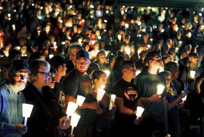People take part in a candlelight vigil following the mass shooting in Roseburg, Oregon. Pic/AFP
