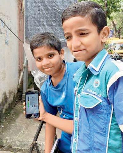Sahil Parab (holding the phone) and Harsh Mahadikar have been measuring noise levels with another friend near their area in BDD chawl