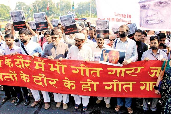 Making a point: Writers and activists on a solidarity march with black gags and arm bands in New Delhi on Friday, after which the Sahitya Akademi condemned the murder of MM Kalburgi. Pic/PTI