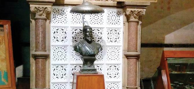 A bust of Shivaji Maharaj stands at the entrance of the main heritage building
