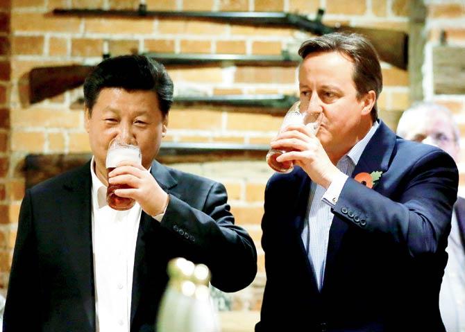 China’s President Xi Jinping and Britain’s Prime Minister David Cameron enjoy a pint at The Plough pub on Thursday in Princes Risborough, England. Xi’s state visit comes a decade after Chinese president Hu Jintao visited the UK in 2005. Pic/Getty Images