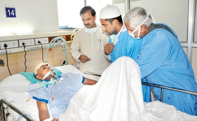 Tourism Minister Mahesh Sharma meets Danish Iqlakh, who was assaulted by a mob over rumours of cow slaughtering and stacking beef. His father Mohammed was lynched by the same mob. File pic/PTI
