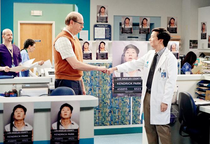 Ken Jeong (in a lab coat) in a still from the  TV show, Dr Ken