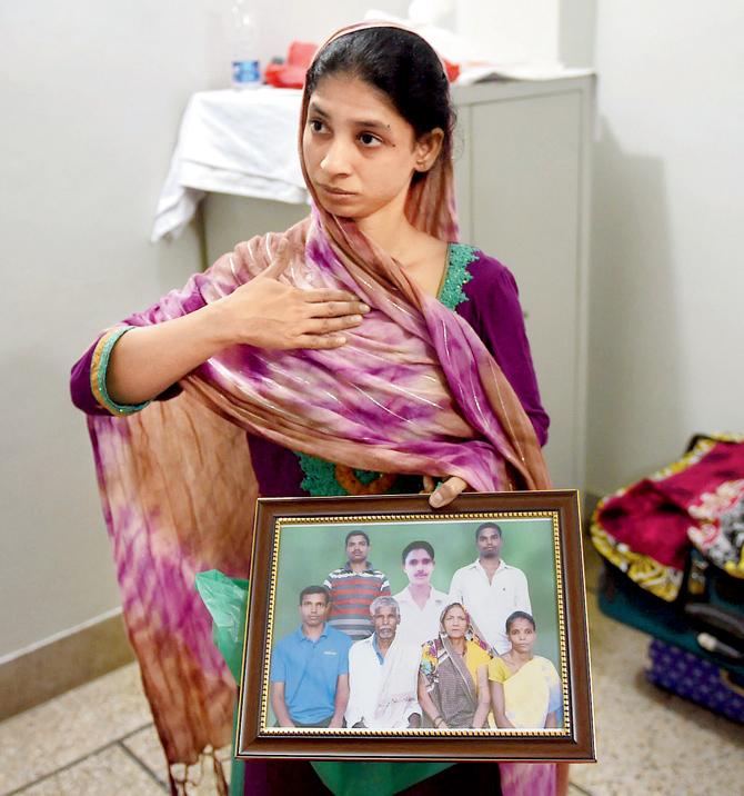 Geeta holds a photograph of an Indian  family, which she believes is her own