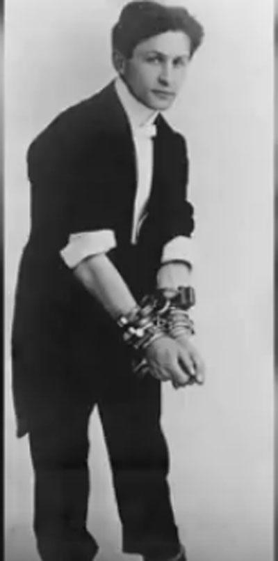 Harry Houdini handcuffed before the Mirror escape challenge. Pic/YouTube