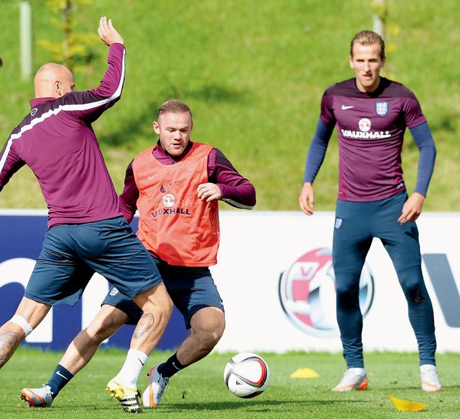 Wayne Rooney (right) gets past Jonjo Shelvey during an England training session at     St George’s Park yesterday in Burton-upon-Trent. PIC/Getty Images 