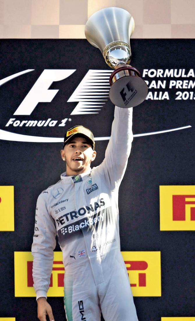 Lewis Hamilton celebrates          on the podium after winning the Italian GP in Monza yesterday. PIC/AFP