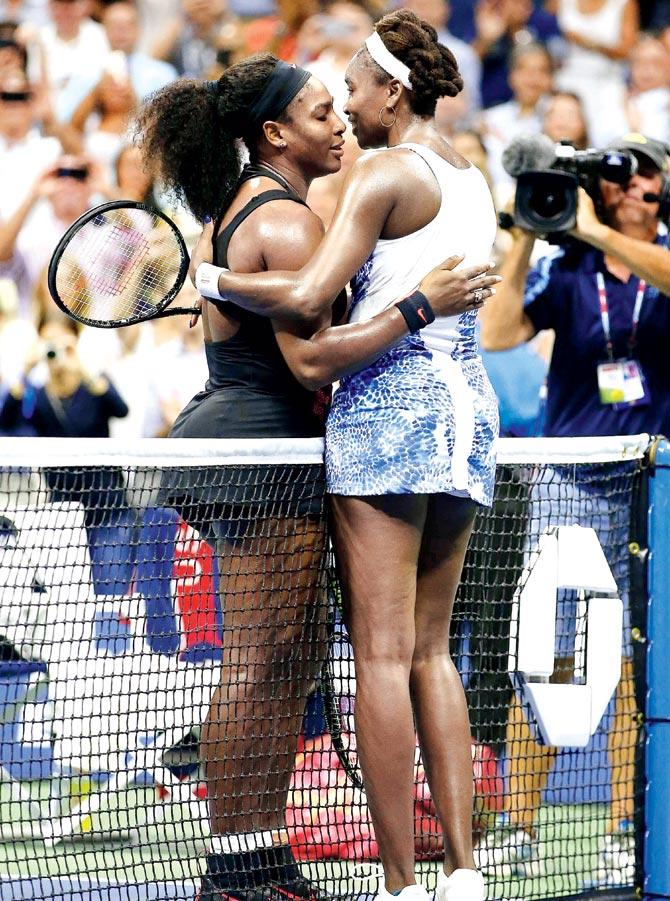 Serena Williams (left) hugs Venus Williams after defeating her in their quarter-final clash on Tuesday. Pic/AFP