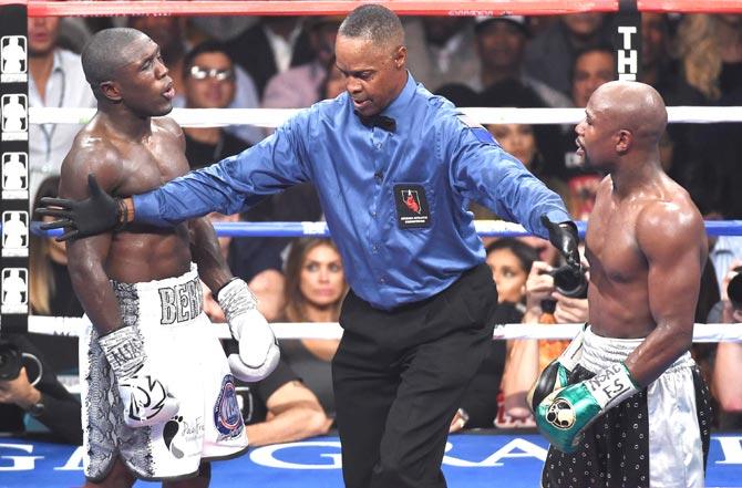 Referee Kenny Bayless (C) separates Andre Berto (L) and Floyd Mayweather Jr. (R) during the seventh round of their WBC/WBA welterweight title fight at MGM Grand Garden Arena in Las Vegas. Pic/AFP