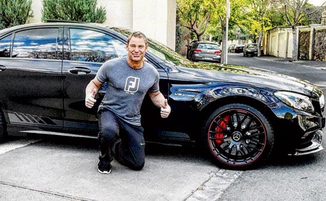 Shane Warne poses with his new car. Pic/Instagram