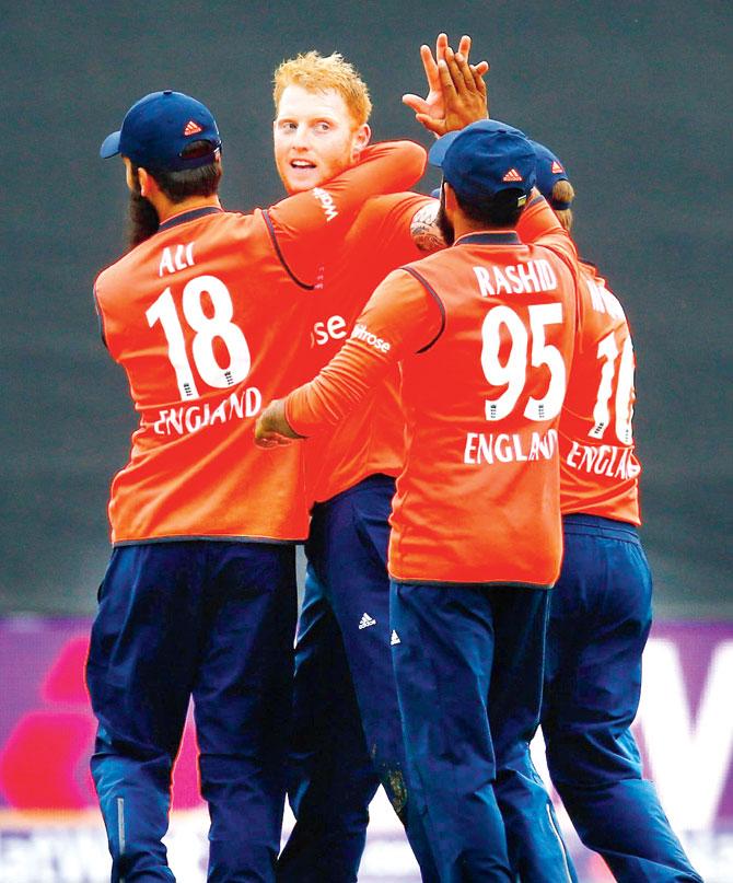 Ben Stokes is congratulated by England teammates after running out Australia