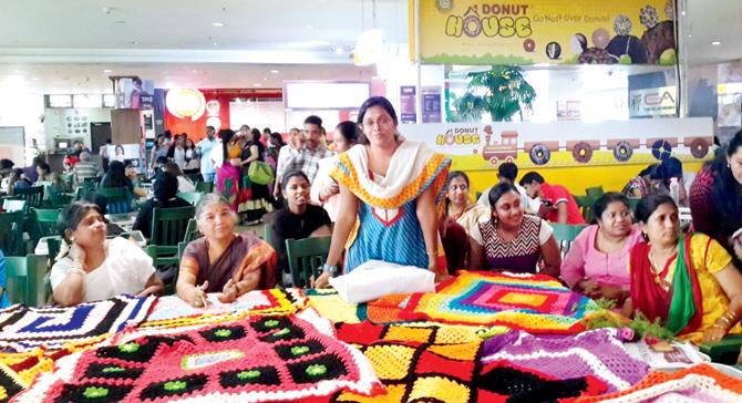 A group knitting session in progress at a mall in Chennai