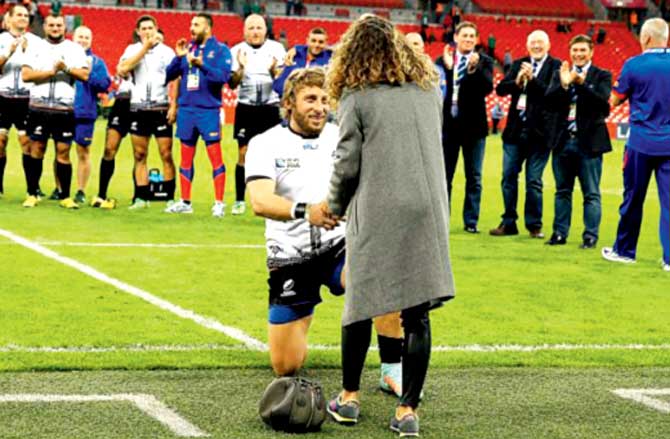 Romanian Florin Surugiu proposes to his girlfriend at Wembley on Sunday. Pic/AFP