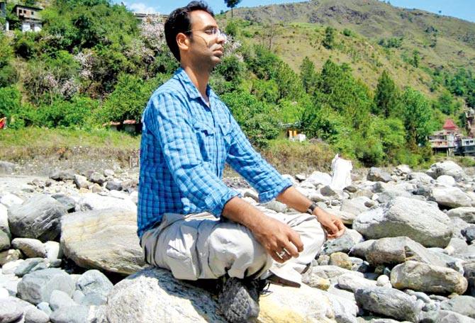 Bajaj practising yoga on the banks of Ganges
