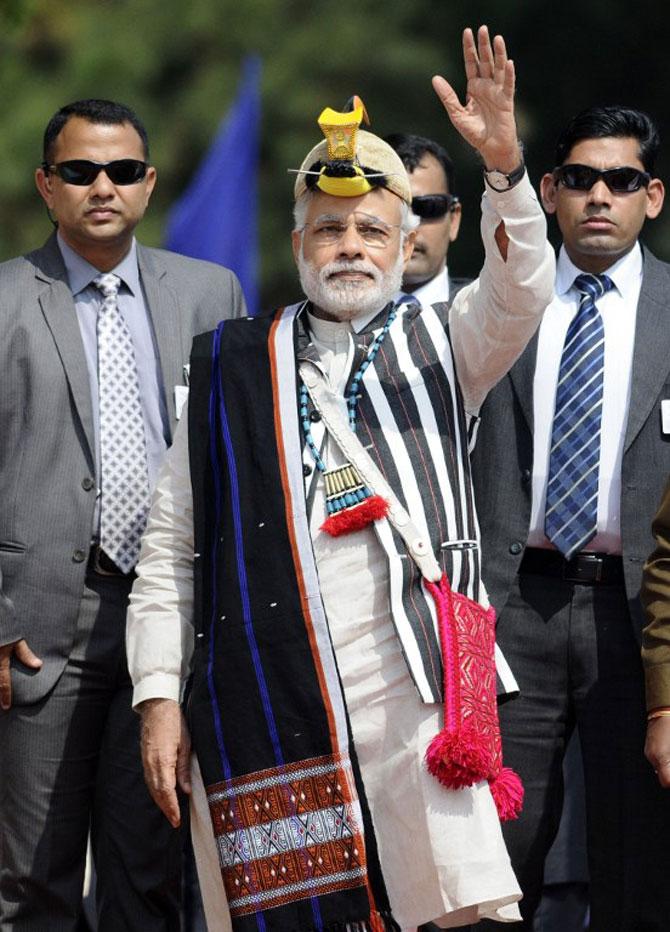 Indian Prime Minister Narendra Modi gestures to crowds