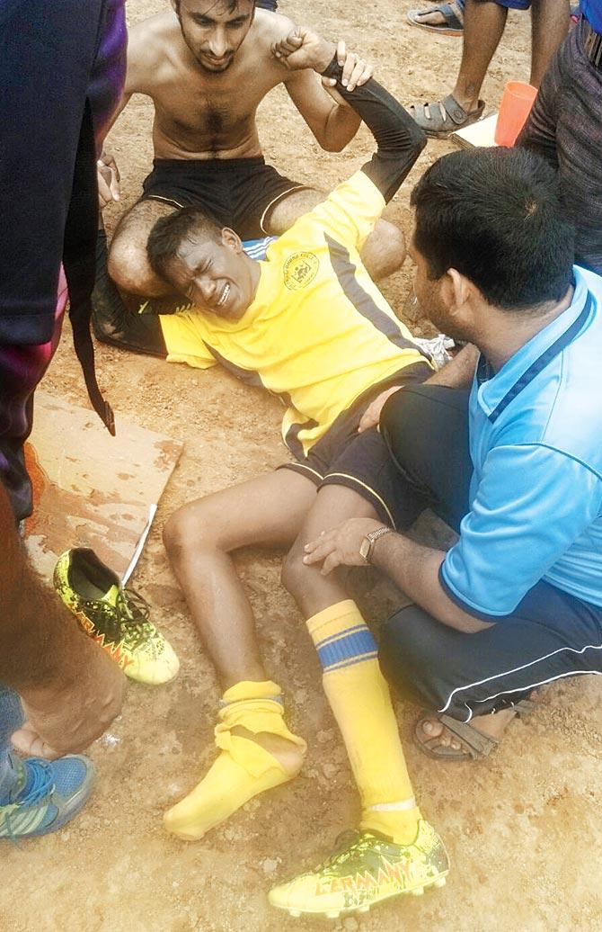 Dnyanasadhana College (Thane) defender Ajay Jaiswal winces in pain after he breaks his shin during a Mumbai University inter-college football match at the RKT College Ground in Panvel yesterday 