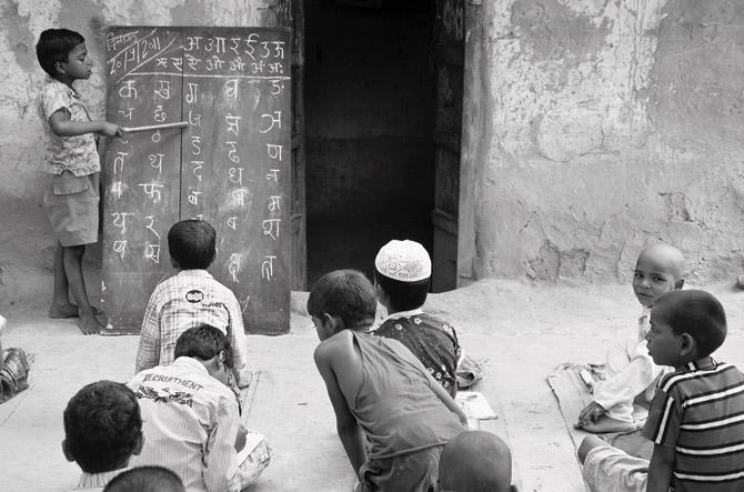 Boy teaching Hindu Muslim boys