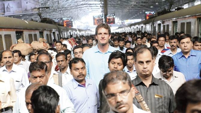 Six-foot-plus presenter Dan Snow towers over commuters at CST
