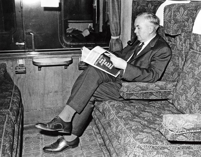A 1965 photograph of British Prime Minister Harold Wilson reading The Economist magazine in a train carriage at Paddington Station, London. The 172-year-old brand continues to stand the test of time. Pic/Getty Images