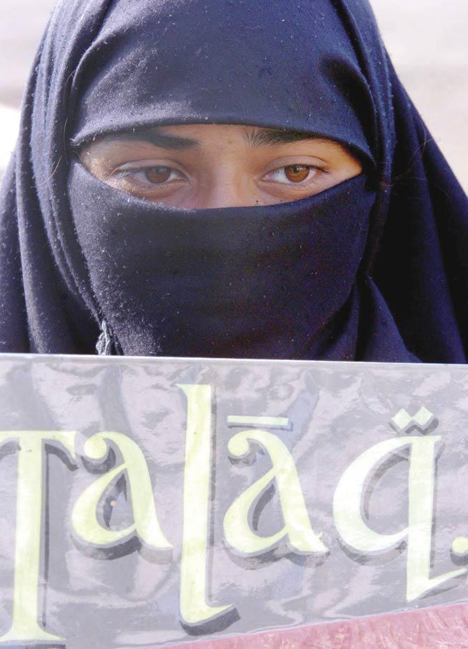 File picture of a girl standing with a poster denouncing talaq (divorce) on the occasion of the International Women’s Day. Pic/AFP
