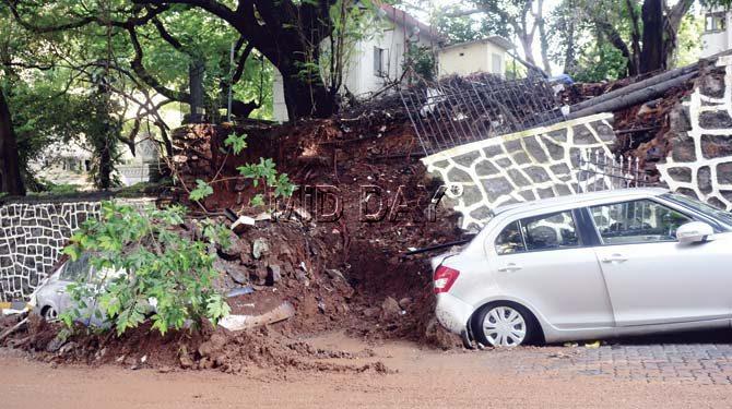 The cars were buried under mounds of mud, bricks and tree branches. Several cars have suffered heavy damage, leaving their owners visibly perturbed. Pics/Bipin Kokate
