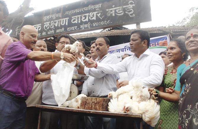 Maharashtra Navnirman Sena (MNS) party workers sell chicken to protest against the meat ban
