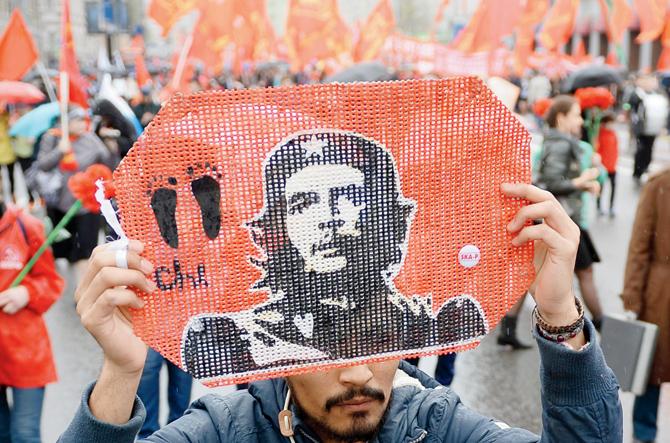 A Russian Communist Party activist holds up a portrait of Che Guevara during their traditional May Day rally on  May 1, 2015 in Moscow.  FIle pic/afp
