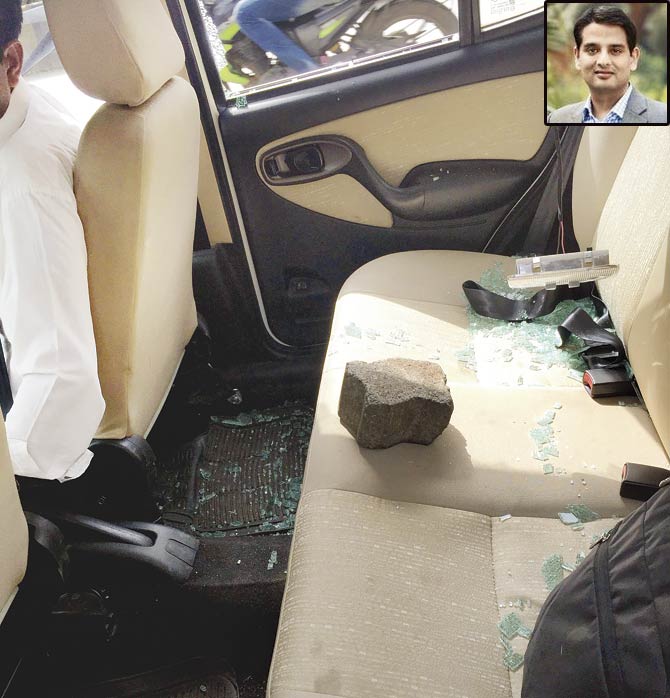 The mob threw a brick that broke the window and landed on the back seat, inches away from the passenger, Nitin Sharma