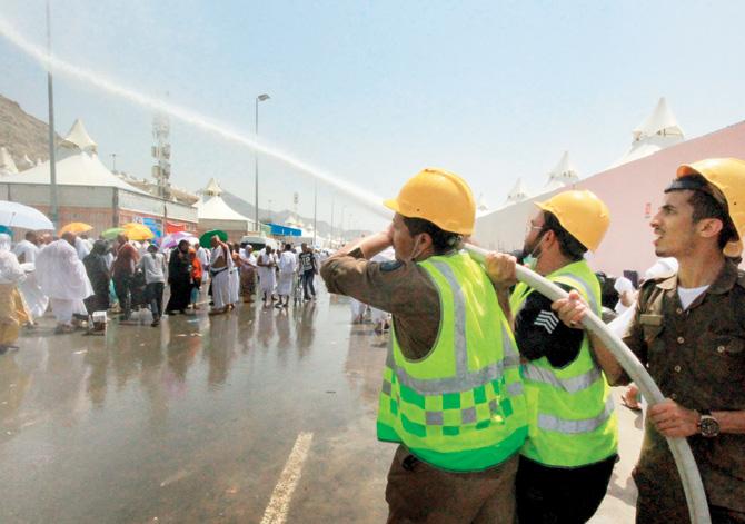 Saudi emergency personnel spray water to cool down Hajj pilgrims at the site. PICs/AFP