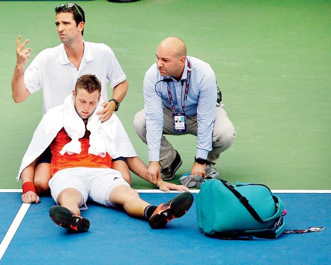 Jack Sock receives assistance for heat exhaustion  during his Round 2 match on Thursday. PIC/AFP