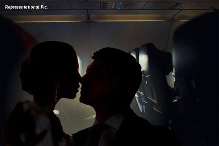 Shot in the dark: This rumoured couple indulged in PDA on flight