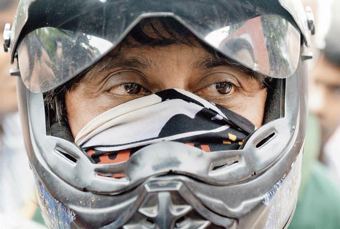 Siddharth Das spoke to media persons in Kolkata yesterday, but chose to hide his face behind a helmet. Pic/PTI