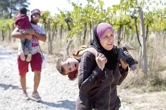 A family crossing the Greek-Macedonian border near the town of Gevgelija on Friday