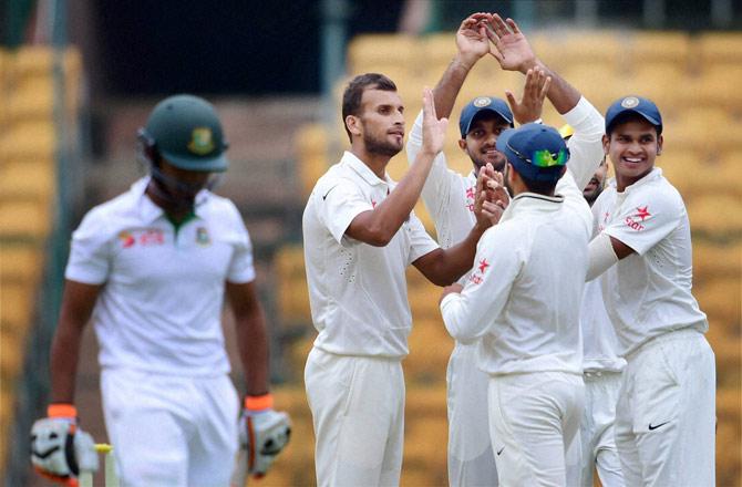 India A bowler Ishwar Pandey with team mates celebrates the wicket of Anamul Haque