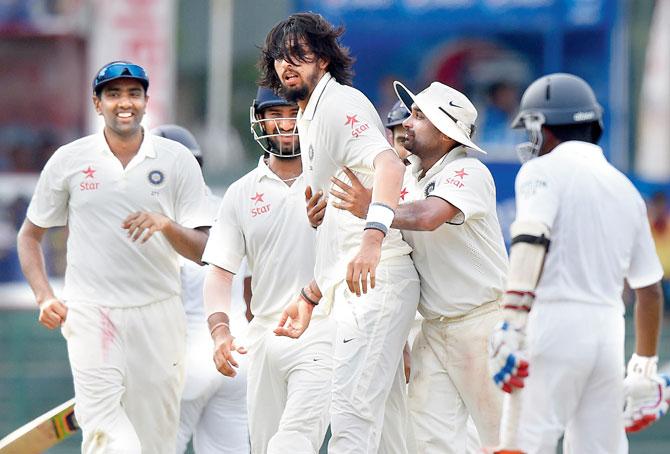 Ishant Sharma (centre) celebrates with teammates the wicket of Lanka