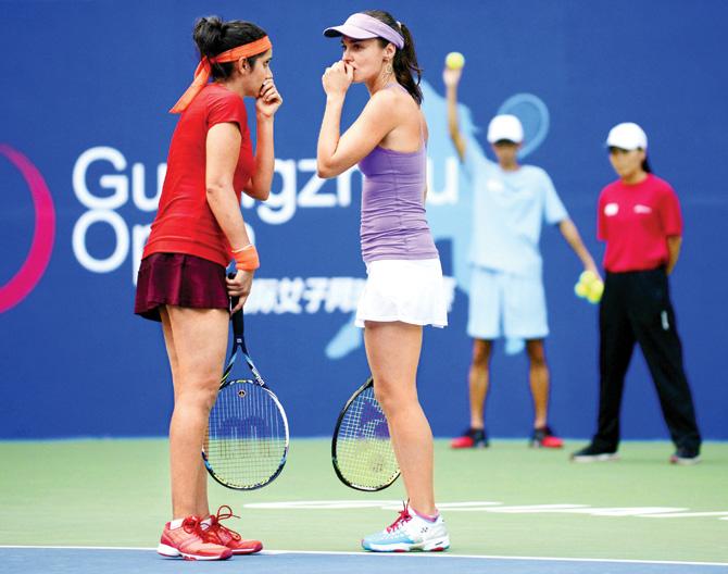 India’s Sania Mirza (left) and Martina Hingis of Switzerland during the Guangzhou Open women’s doubles final against China’s Xu Shilin and You Xiaodi on Saturday. pics/afp