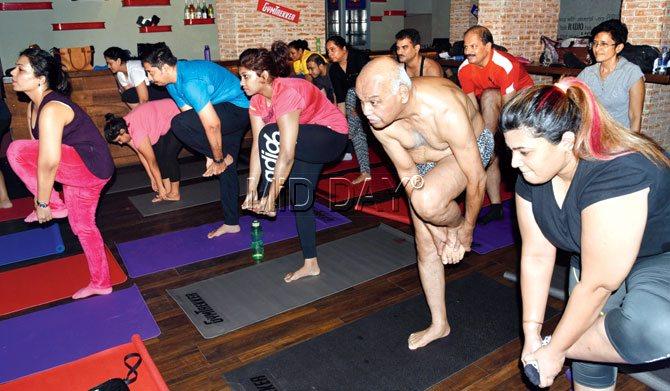 Participants take part in a yoga session, conducted by Mickey Mehta