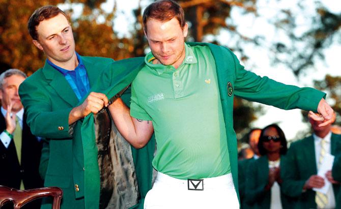 Jordan Spieth (left) presents Danny Willett with the Green Jacket after the Englishman won the final round of the 2016 Masters in Augusta on Sunday. Pic/AFP