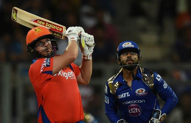 Gujarat Lions Aaron Finch (L) watched by Mumbai Indians wicketkeeper Parthiv Patel plays a shot during the 2016 Indian Premier League(IPL) Twenty20 cricket match between Gujarat Lions and Mumbai Indians at the Wankhede Stadium in Mumbai. AFP Photo