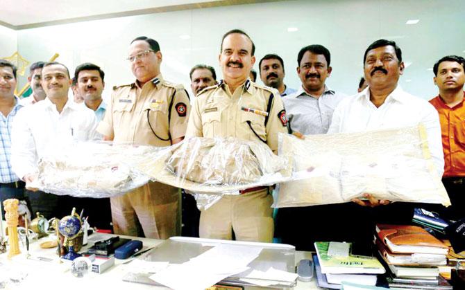 Police officials with the seized consignment of psychotropic substances ephedrine and mephedrone
