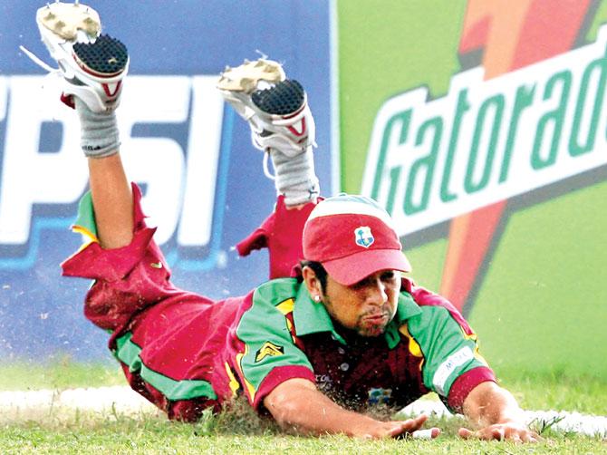 West Indies cricketer Ramnaresh Sarwan unsuccessfully dives to stop a boundary by New Zealand