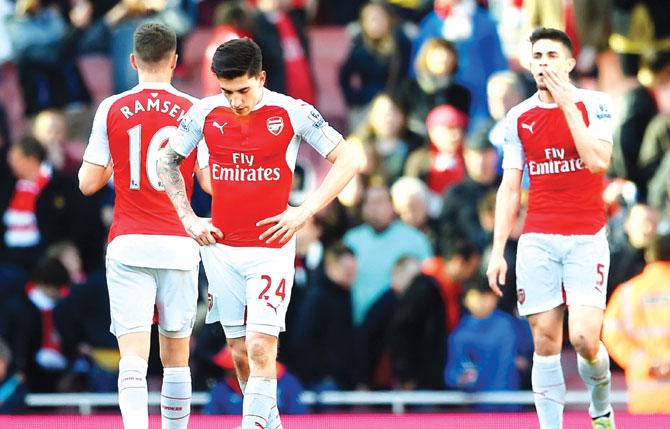 Arsenal players sport a dejected look after their EPL match against Crystal Palace at Emirates Stadium in London yesterday. Pic/Getty Images