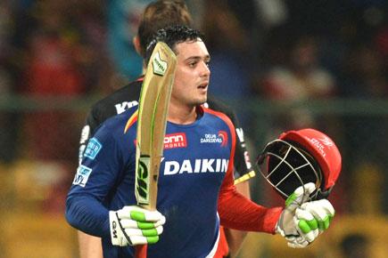 Delhi Daredevils batsman Quinton De Kock raises his bat after scoring 100 runs during the 2016 Indian Premier League (IPL) Twenty20 cricket match between Royal Challengers Bangalore and Delhi Dardevils, at M Chinnaswamy Stadium in Bangalore