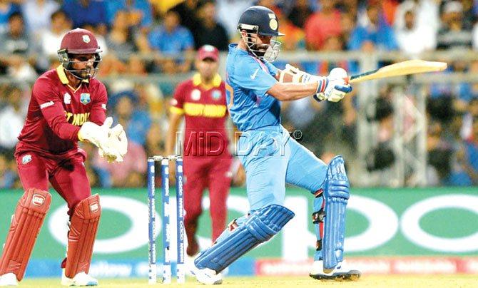 India batsman Ajinkya Rahane plays on the leg-side as West Indies wicketkeeper Denesh Ramdin looks on during their semi-final match at the Wankhede Stadium in Mumbai yesterday. Pic/Suresh Karkera