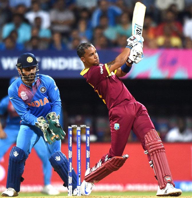 West Indies batsman Lendl Simmons (R) plays a shot as India